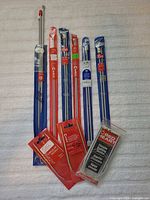 Overall lot showing nine unopened knitting needle packages