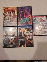 Front view of five DVD cases including The Hangover, A Night at the Roxbury, Due Date, Hot Fuzz, The Other Guys