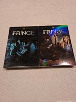 Front view of Seasons 1 and 2 slipcase box sets side by side