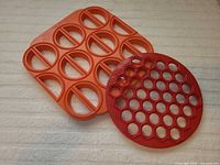 Orange 12-cavity mold and red 36-cavity mold side by side