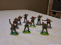 Eight soldiers on green bases in various poses
