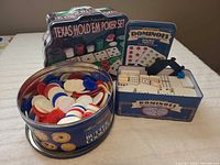 Overview of poker set tin, dominoes tin, cookie tin with chips