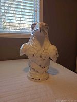 Front view of white ceramic eagle bust