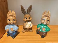 Front view of all three ceramic bunny figurines
