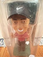 Front view of Tiger Woods bobblehead inside sealed packaging