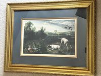 Full view of framed print showing gold frame and navy mat