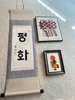 Overview of all three art pieces: scroll, textile weave, crewel girl