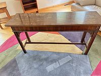 Full view of wood console table top and legs