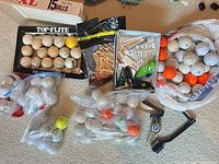 Top view of mixed golf balls, boxes and accessories