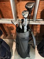 Full view of black nylon golf bag loaded with clubs