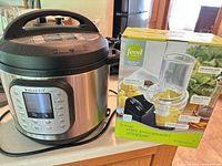 Instant Pot Duo Nova cooker next to boxed Food Network 3-cup mini processor