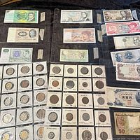Overview of coins in flips and multiple banknotes in sleeves