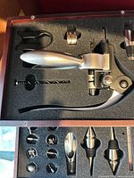 Open presentation case showing lever corkscrew and accessories in foam insert