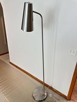 Full view of chrome floor lamp showing height, stem, shade and base
