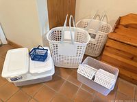 Group shot showing hampers, clear bins, white basket with trays, blue basket