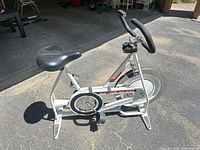Full side view of Schwinn DX900 bike showing frame, seat, handlebars, flywheel