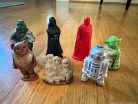 All seven erasers displayed upright on wooden floor