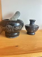 Both mortar and pestle sets on shelf