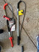 Ridgid and BrassCraft toilet augers side by side on floor
