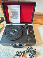 Turntable open with manual and cable visible