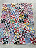 Full view of baby quilt showing overall pattern and colours