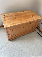 Front and top view of pine chest showing bun feet and panelled front