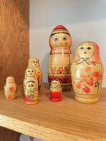 Six wooden nesting dolls on shelf