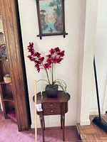 Full view of side table with faux orchid on top