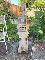 Front view of full lantern beside chair, tape measure showing overall height