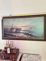 Front view of framed seascape painting showing artwork, frame detail and overall size
