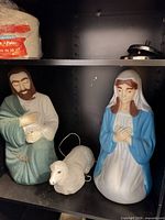 Mary, Joseph and lamb blow-mold figures on shelf