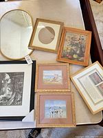 All seven framed pieces laid out on table