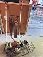 All items grouped: two pipe clamps, two hand saws, three circular saws, one palm router, one suction cup