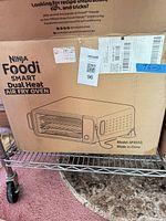 Sealed box showing Ninja Foodi Smart Dual Heat Air Fry Oven SP351Q