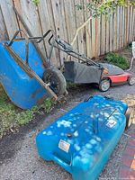Blue Valterra water tote on ground with wheels and cap visible