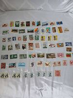 Overview of 70 mixed Australian stamps laid out on white background
