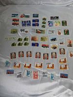 Full layout of roughly 60 Canadian stamps showing variety of designs and denominations