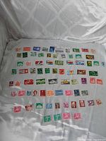All 74 Swiss stamps arranged on fabric background
