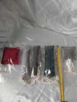 Five sealed catnip kicker toys with ruler for scale