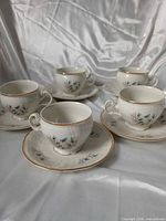 Group view of all five cup and saucer pairs