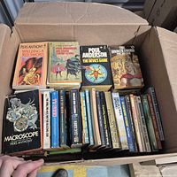 Open box showing rows of vintage paperback novels