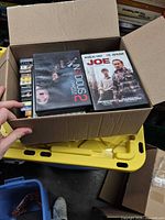 Open box with visible Insidious: Chapter 2 and Joe DVDs plus assortment beneath