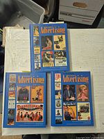 Three hardcover volumes laid out showing front covers