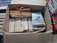 Box filled with spine-visible digest magazines, top issue Analog Feb 1976