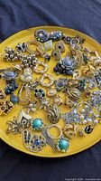 Overview of assorted earrings on yellow plate