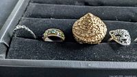 First four rings including enamel band and dome ring
