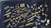 Entire tray showing assortment of cufflinks, tie bars and tacks