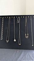 All six necklaces displayed on board