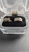 Both rings in presentation box, crystal flower ring left, crystal band right