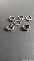 Top view of six sterling silver toe rings arranged flat
